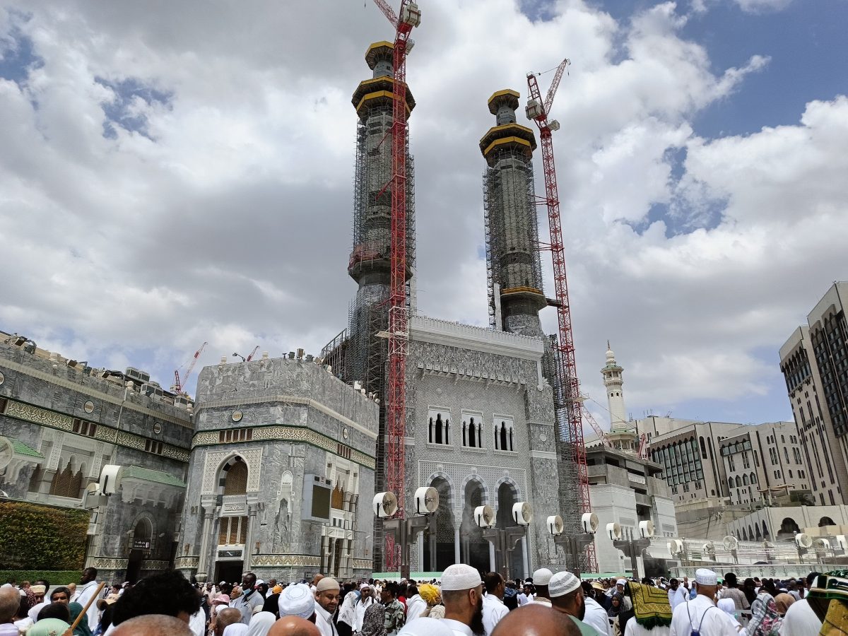 Pilgrims moving through arches near the Haram